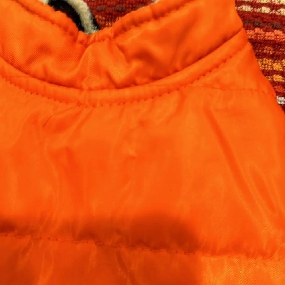Small orange dog vest pockets are for decoration only.
